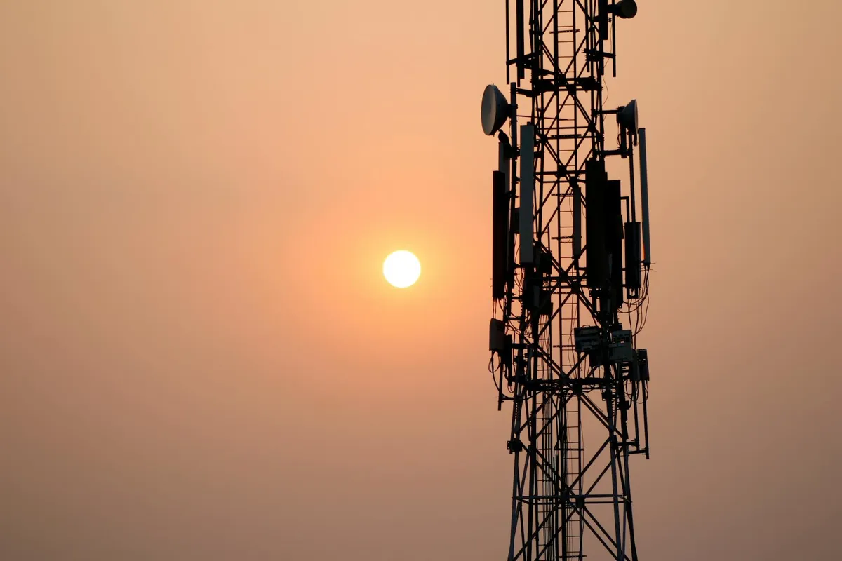 A cellular tower against the morning sky